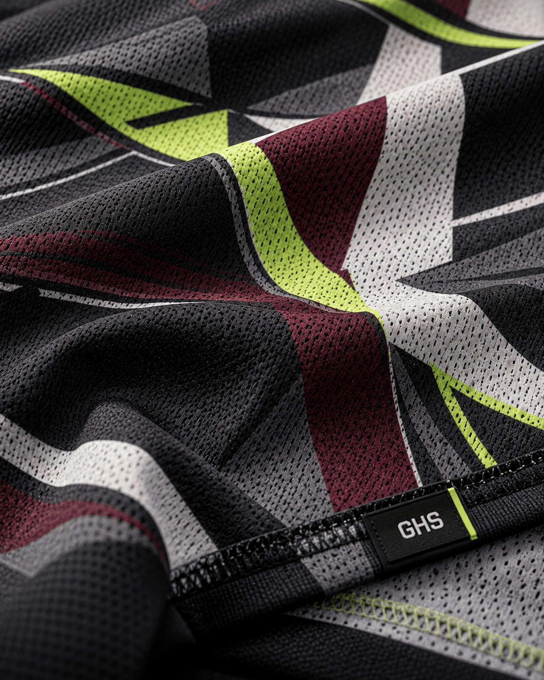 Close-up of dye-sublimated polyester sportswear fabric showing printed graphics and performance textile weave